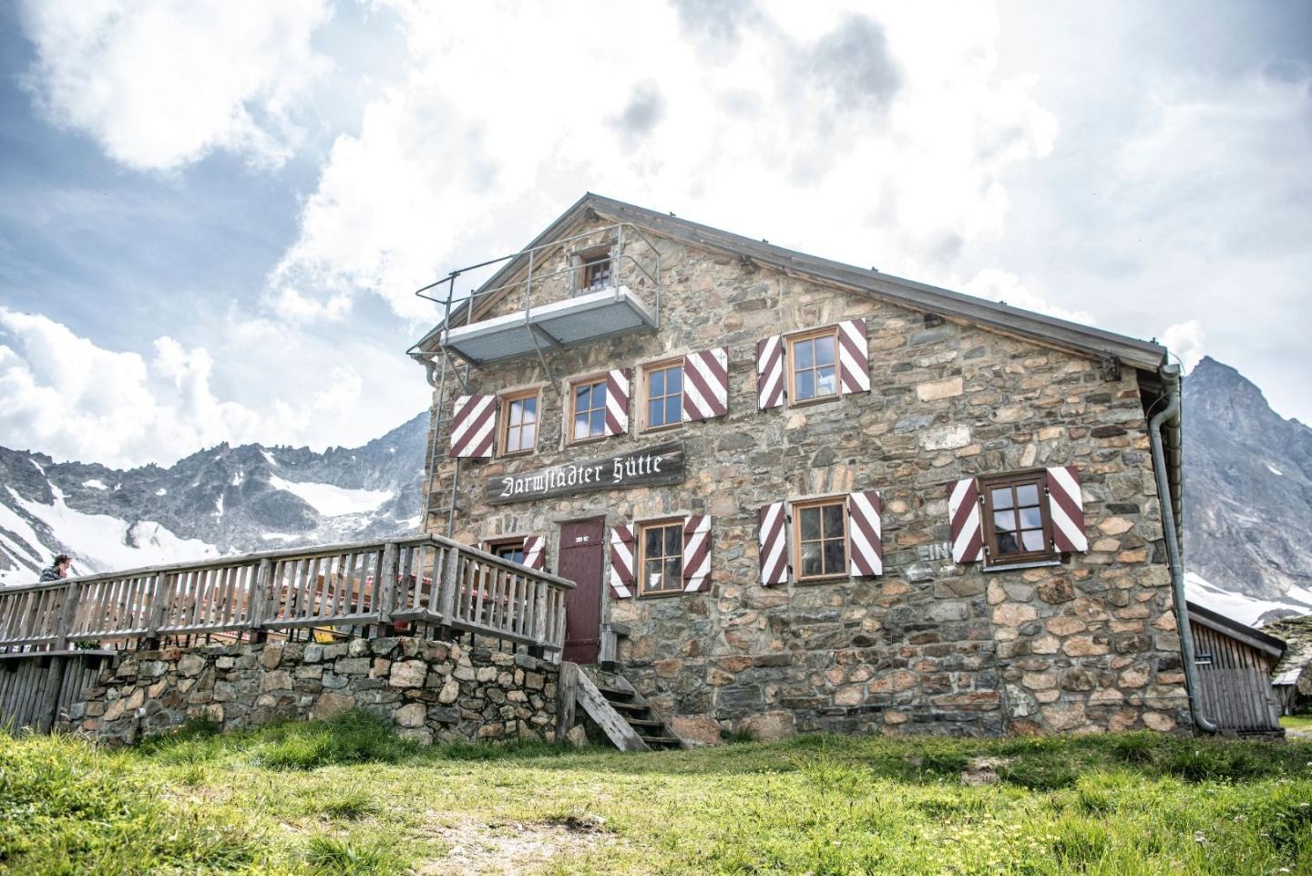 The stone-built Darmstädter Hütte in summer below glacier and peaks on the Arlberg