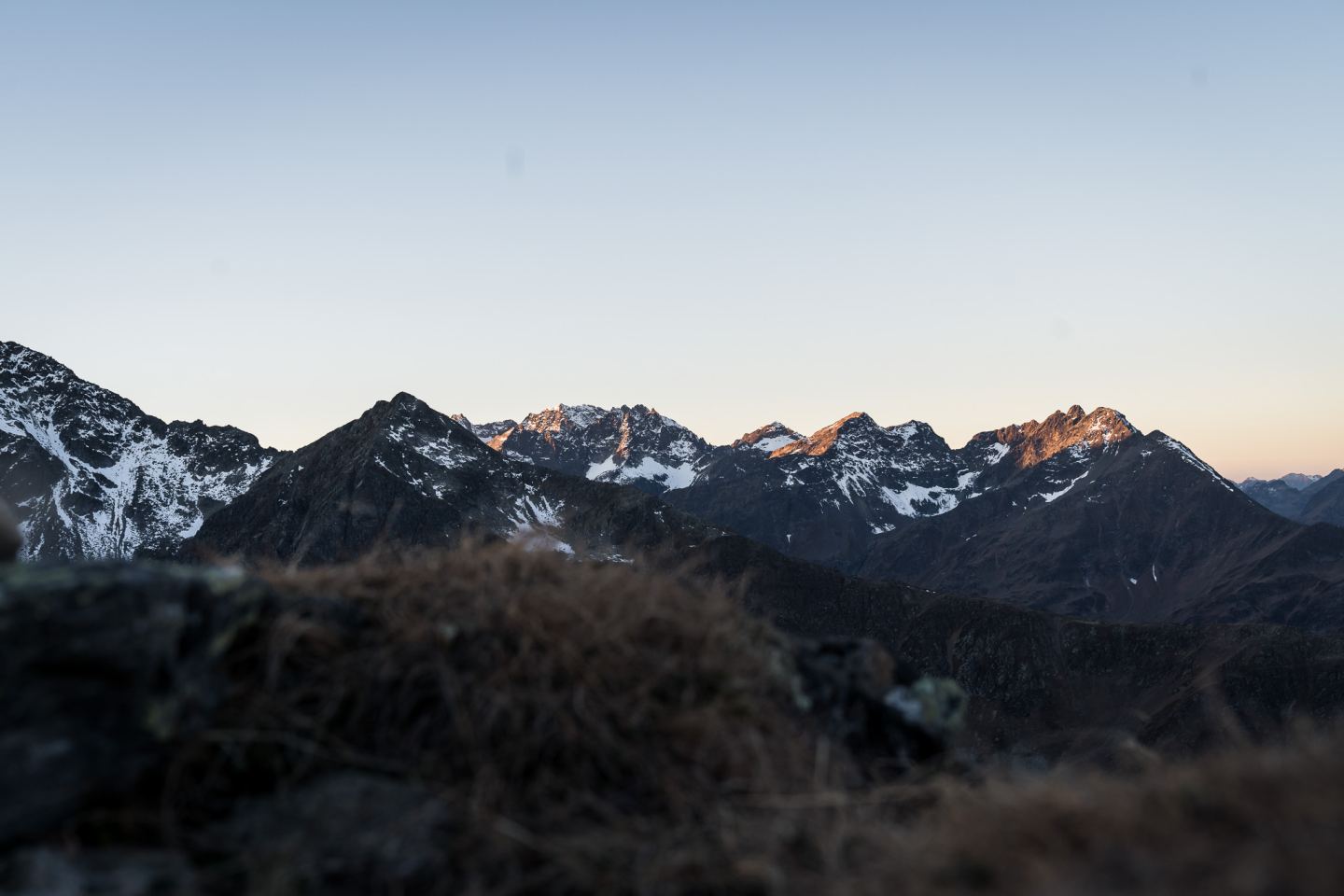 Mountain range with the first alpenglow at dawn on the Arlberg