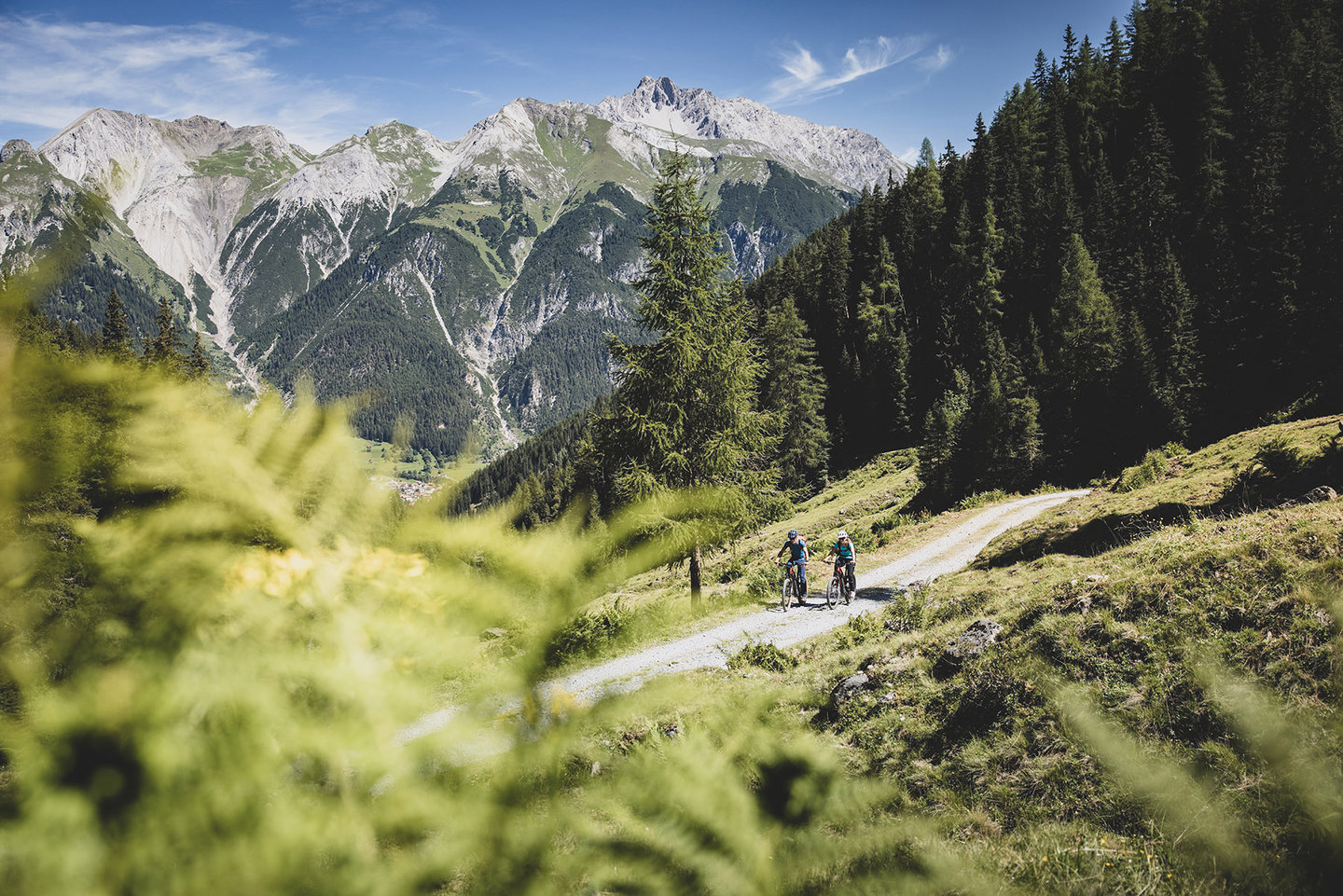 Two mountain bikers on a trail with mountain panorama in summer at the Hoher Riffler, St. Anton am Arlberg